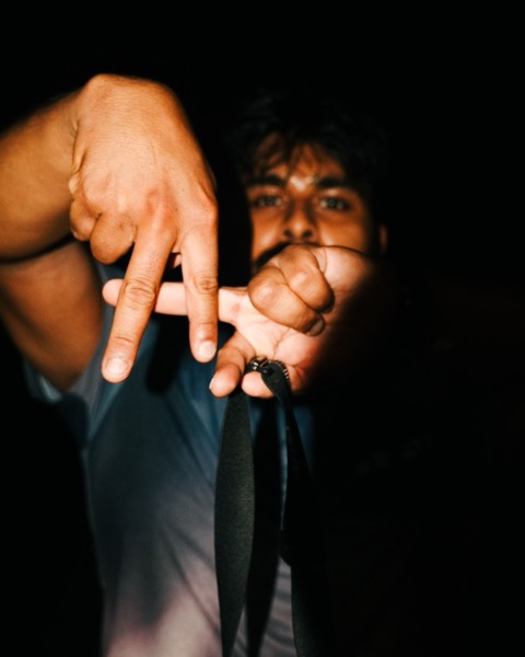 A runner throwing hand signs at the After Hours 3K