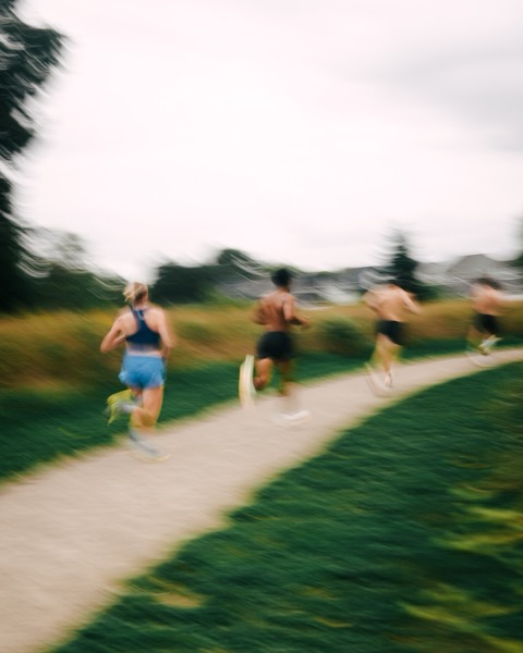 Runners on a paved path at the After Hours 3K
