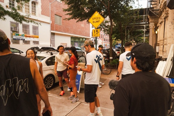 Runners gathering on the sidewalk before Supermarket Race 1