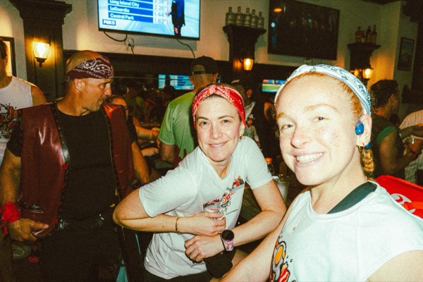 Two runners in bandanas smiling in a bar after The Warriors 2026